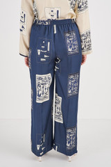 Profile view of model wearing the Oroton Knots & Flag PJ Pant in North Sea and 100% Silk for Women