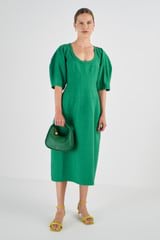 Profile view of model wearing the Oroton Sculptured Dress in Kelly Green and 58% Viscose 42% Linen for Women