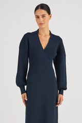 Profile view of model wearing the Oroton Long Sleeve Rib Knit Dress in North Sea and 83% Viscose 17 % Polyester for Women