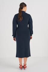 Profile view of model wearing the Oroton Long Sleeve Rib Knit Dress in North Sea and 83% Viscose 17 % Polyester for Women