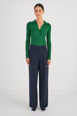 Profile view of model wearing the Oroton Tab Detail Pleat Pant in North Sea and 58% Viscose 42% Linen for Women