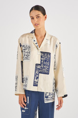 Profile view of model wearing the Oroton Long Sleeve Knots & Flag Print Shirt in Vanilla Bean and 100% Silk for Women