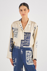 Profile view of model wearing the Oroton Long Sleeve Knots & Flag Print Shirt in Vanilla Bean and 100% Silk for Women