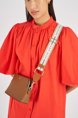 Profile view of model wearing the Oroton Heather Webbing Strap in Cognac/Natural and  for Women