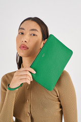 Profile view of model wearing the Oroton Eve Medium Pouch in Emerald and Pebble Leather for Women