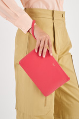 Profile view of model wearing the Oroton Eve Medium Pouch in Peony Pink and Pebble Leather for Women