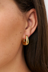 Profile view of model wearing the Oroton Raelyn Hoops in Gold and  for Women