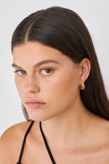 Profile view of model wearing the Oroton Raelyn Hoops in Gold and Brass for Women