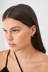 Profile view of model wearing the Oroton Sierra Mini Hoops in Gold and  for Women