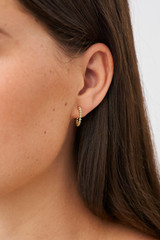Profile view of model wearing the Oroton Sierra Mini Hoops in Gold and  for Women