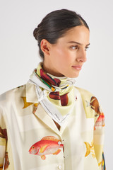 Profile view of model wearing the Oroton Botanical Fish Silk Scarf in Multi and 100% Silk for Women