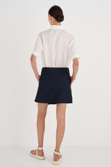 Profile view of model wearing the Oroton Wrap Skirt in North Sea and 58% Viscose, 42% Linen for Women