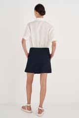 Profile view of model wearing the Oroton Wrap Skirt in North Sea and 58% Viscose, 42% Linen for Women