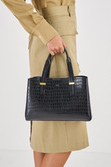 Profile view of model wearing the Oroton Anika Texture Small Day Bag in Black Croc and  for Women