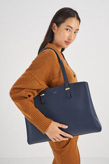 Profile view of model wearing the Oroton Anika 15" Day Bag in Dark Navy and  for Women