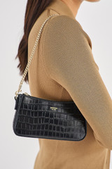 Profile view of model wearing the Oroton Inez Texture Chain Wristlet in Black Croc and Embossed Croc Leather for Women