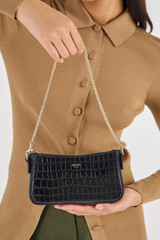 Profile view of model wearing the Oroton Inez Texture Chain Wristlet in Black Croc and Embossed Croc Leather for Women