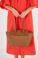Profile view of model wearing the Oroton Iris Medium Day Bag in Cinnamon and Pebble Leather for Women