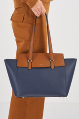 Profile view of model wearing the Oroton Iris Medium Day Bag in Dark Navy/Cinnamon and  for Women