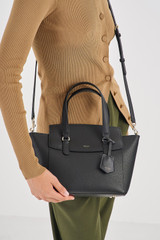 Profile view of model wearing the Oroton Iris Small Day Bag in Black/Black and Pebble Leather for Women