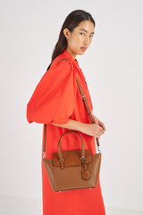 Profile view of model wearing the Oroton Iris Small Day Bag in Cinnamon and Pebble Leather for Women