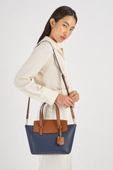 Profile view of model wearing the Oroton Iris Small Day Bag in Dark Navy/Cinnamon and Pebble Leather for Women