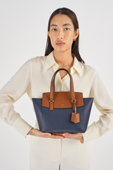 Profile view of model wearing the Oroton Iris Small Day Bag in Dark Navy/Cinnamon and Pebble Leather for Women