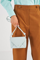 Profile view of model wearing the Oroton Elvie Crossbody in Pale Amalfi and Smooth leather for Women