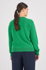 Profile view of model wearing the Oroton Merino Relaxed Polo in Juniper Green and 100% Merino Wool for Women