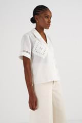 Profile view of model wearing the Oroton Lace Detail Camp Shirt in Antique White and 100% Linen for Women