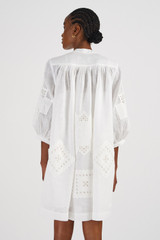 Profile view of model wearing the Oroton Lace Detail Smock Dress in Antique White and 100% Linen for Women