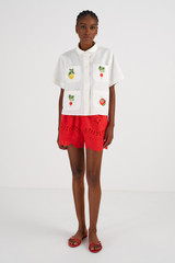 Profile view of model wearing the Oroton Embroidered Vegetable Camp Shirt in White and 100% Linen for Women