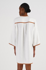 Profile view of model wearing the Oroton Embroidered Vegetable Tunic Dress in Antique White and 100% Linen for Women