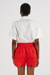 Profile view of model wearing the Oroton Broderie Short in Poppy and 100% Linen for 