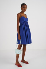 Profile view of model wearing the Oroton Short Bodice Detail Dress in Azure Blue and 100% Cotton for Women