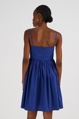 Profile view of model wearing the Oroton Short Bodice Detail Dress in Azure Blue and 100% Cotton for Women