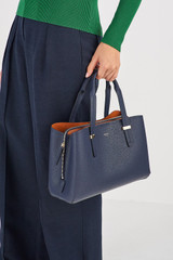 Profile view of model wearing the Oroton Anika Small Day Bag in Dark Navy and  for Women