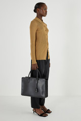 Profile view of model wearing the Oroton Muse 15" Worker Tote in Black and Saffiano leather for Women