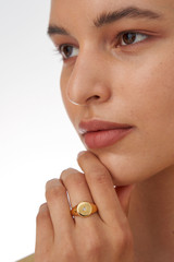 Profile view of model wearing the Oroton Fawne Circle Signet Ring in Gold/Clear and Brass Base With 18CT Gold Plating /Cubic Zirconia for Women