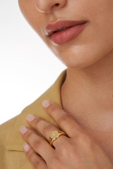 Profile view of model wearing the Oroton Fawne Circle Signet Ring in Gold/Clear and Brass Base With 18CT Gold Plating /Cubic Zirconia for Women