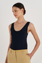 Profile view of model wearing the Oroton Knit Tank in North Sea and 83% Viscose, 17% Polyester for Women
