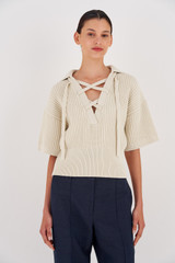 Profile view of model wearing the Oroton Short Sleeve Rib Knit in Vanilla Bean and 100% Cotton for Women