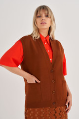 Profile view of model wearing the Oroton Sleeveless Knit Vest in Tan and 83% Viscose, 17% Polyester for Women