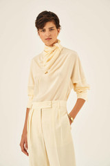 Profile view of model wearing the Oroton Soft Silk Blouse in Pale Saffron and 100% Silk for Women