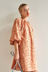 Profile view of model wearing the Oroton Broderie Dress in Soft Clay and 100% Cotton for Women