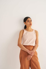 Profile view of model wearing the Oroton Jersey Tank in Pale Mango and 100% Cotton for Women