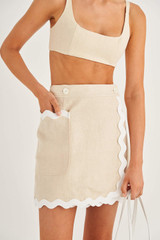 Profile view of model wearing the Oroton Short Wrap Skirt in Ecru and 100% Linen for Women
