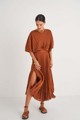 Profile view of model wearing the Oroton Pleated Dress in Cognac and 100% Polyester for Women