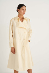 Profile view of model wearing the Oroton Trench Dress in Butter and 100% Cotton for Women