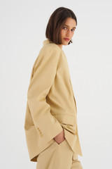 Profile view of model wearing the Oroton Double Breasted Blazer in Cane Sugar and 66% Viscose 34% Cotton for Women